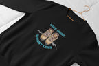 Black crewneck sweatshirt with 'Hike More, Worry Less' hiking boots graphic on chest
