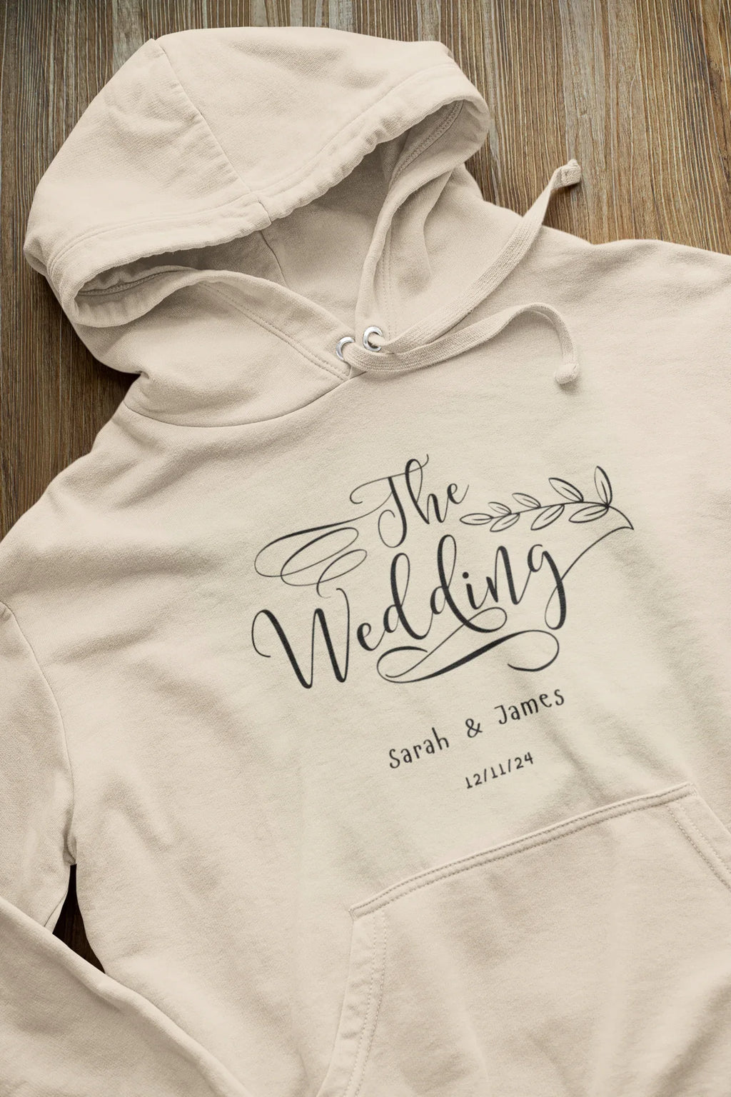 Cream wedding day hoodie sweatshirt with “The Wedding” logo print and drawstring hood