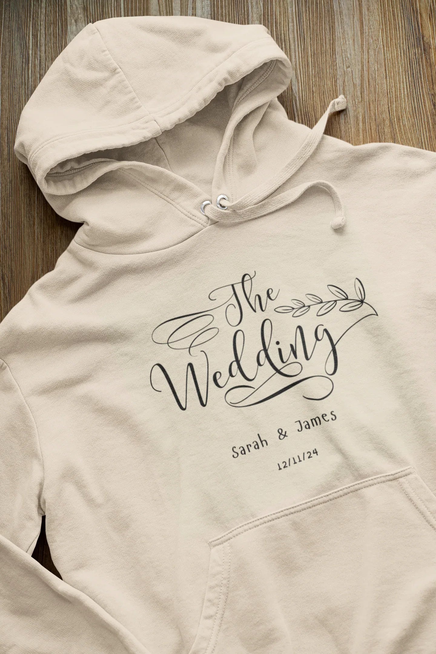 Cream wedding day hoodie sweatshirt with “The Wedding” logo print and drawstring hood