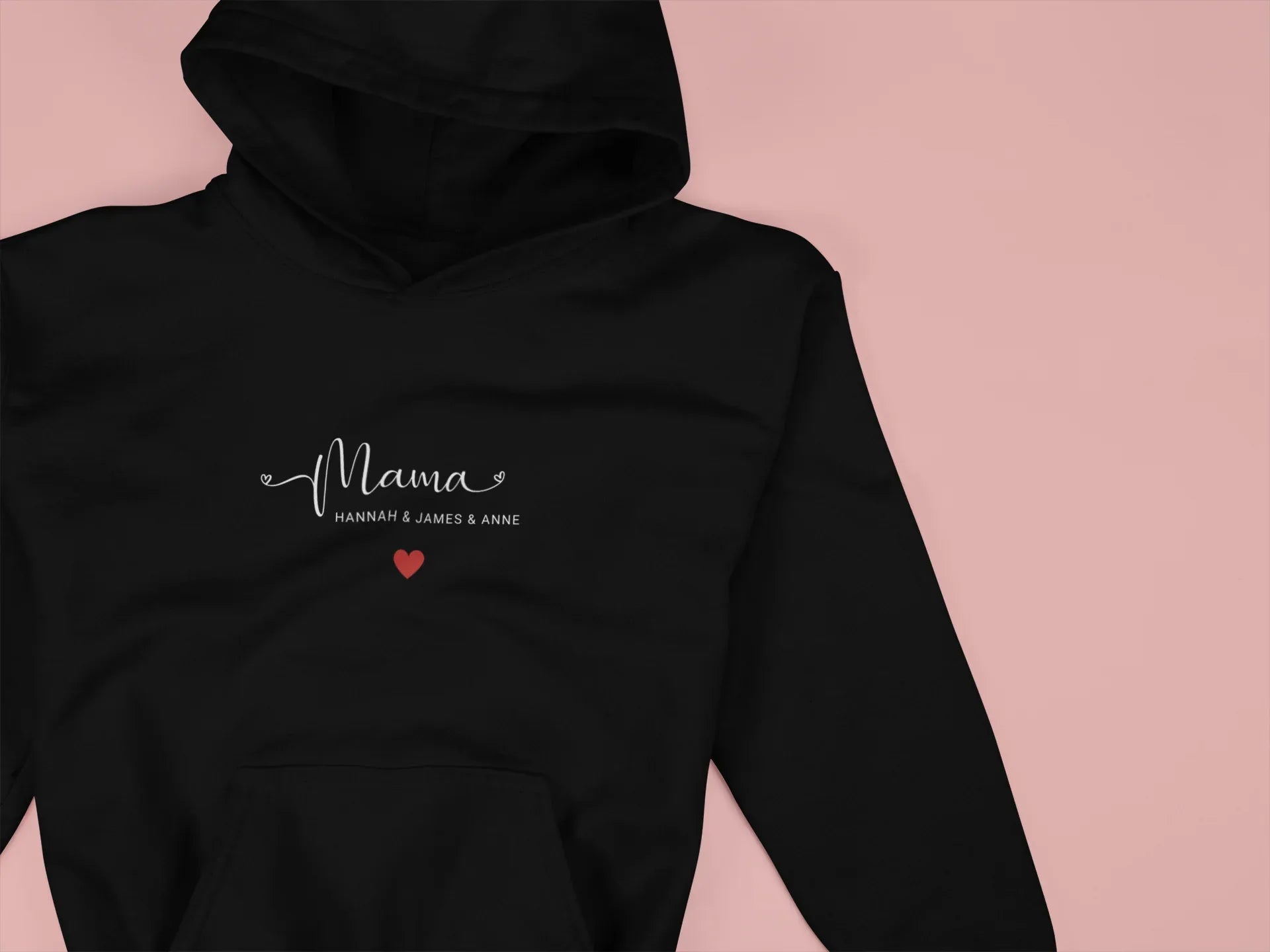 Black hooded sweatshirt chest print of “Mama” with red heart and pocket