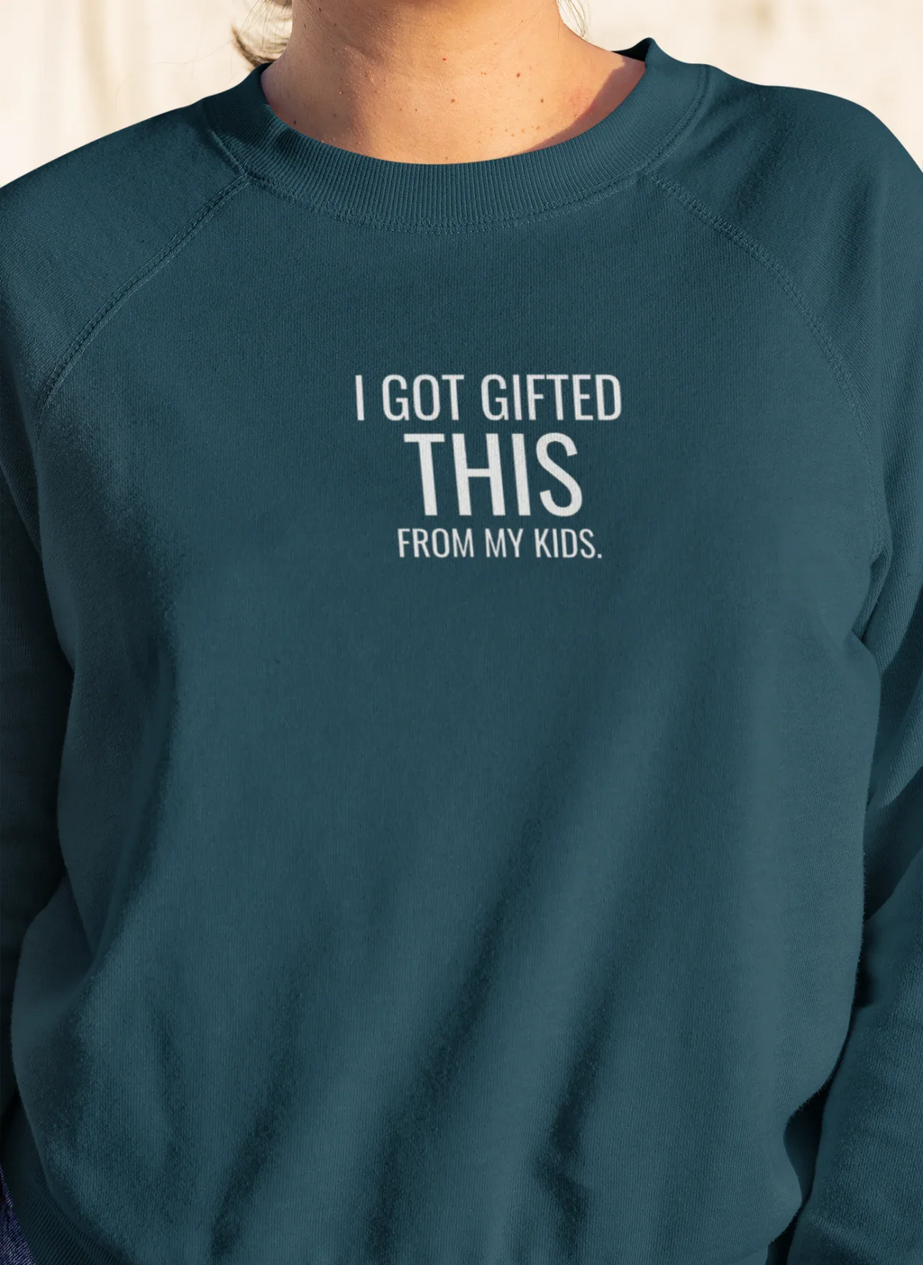 Teal crewneck sweatshirt with "I got gifted this" chest print