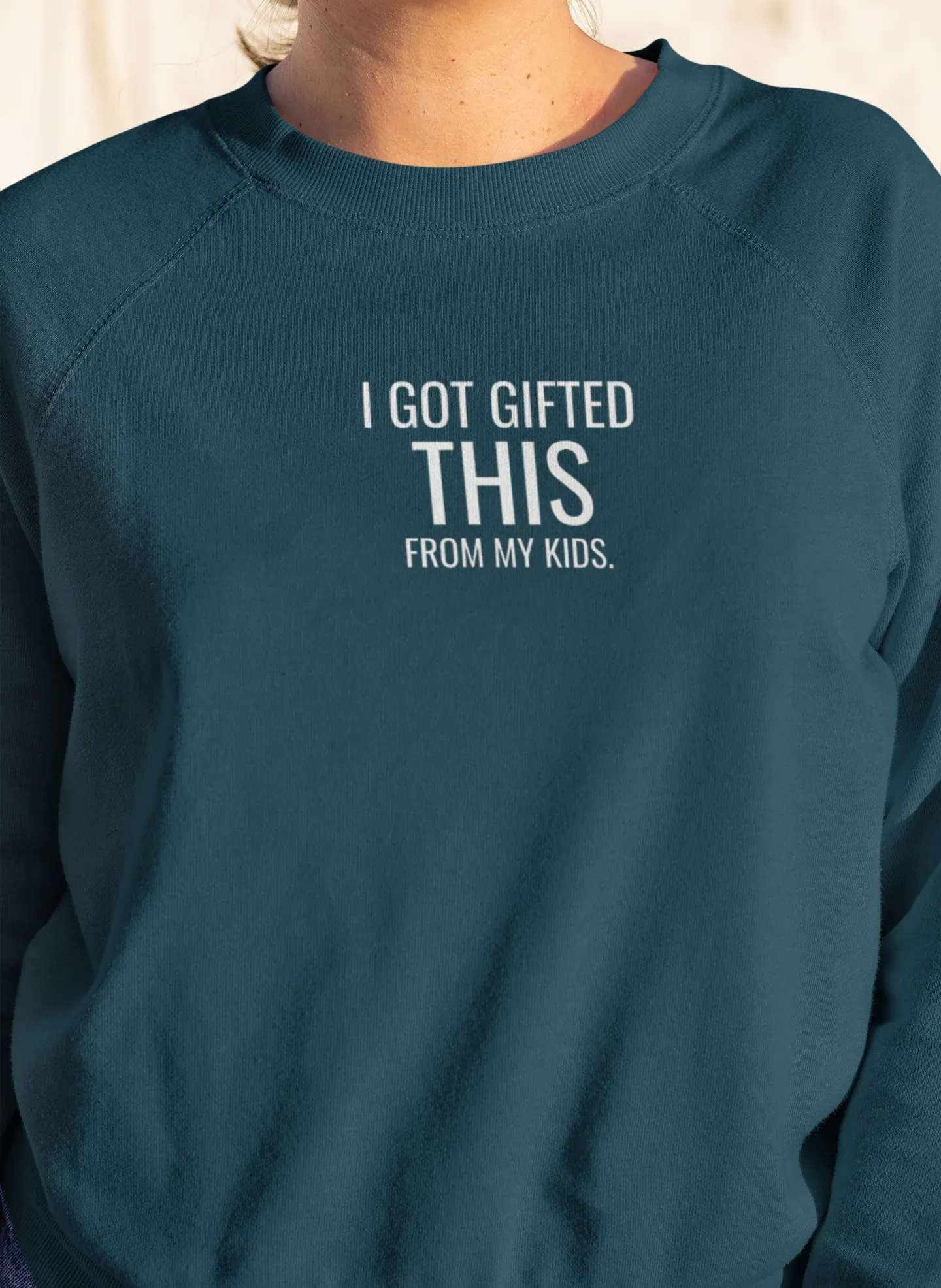 Teal crewneck sweatshirt with "I got gifted this" chest print
