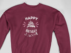 Maroon crewneck sweatshirt with “Happy Birthday Joanie” cake graphic