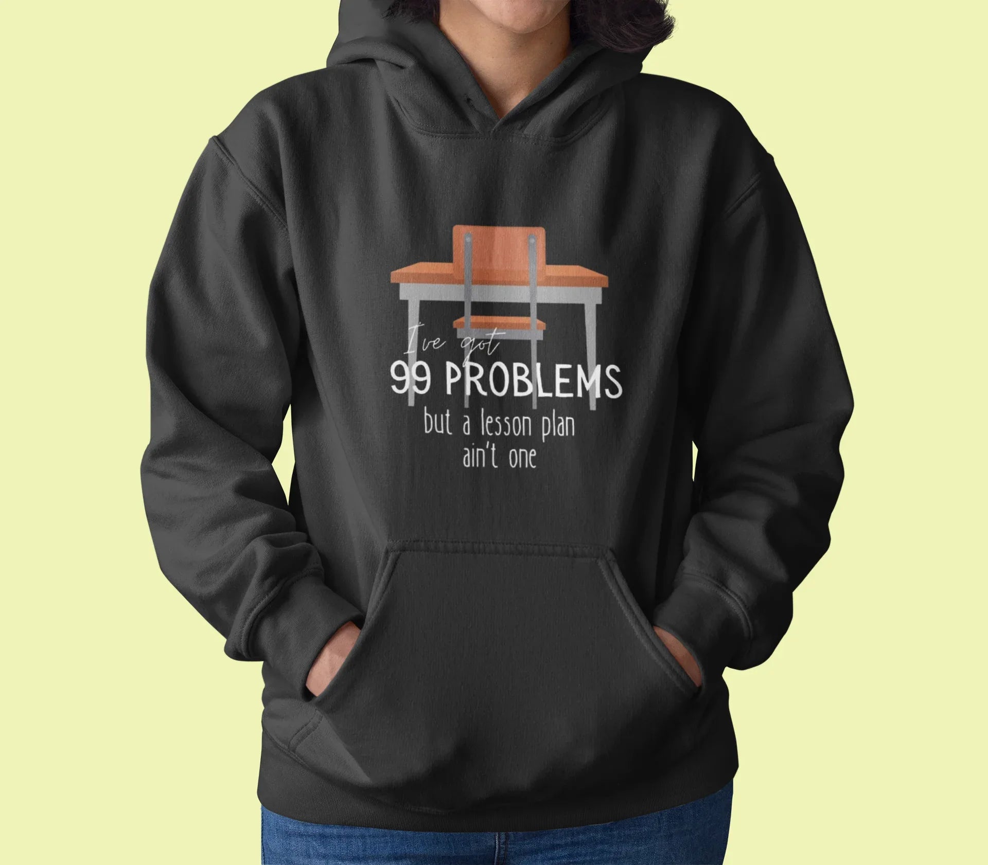 Dark charcoal unisex hoodie with drawstring hood and front pocket; '99 problems' desk graphic.