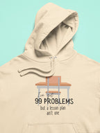 Cream unisex hoodie with front pocket and drawstring hood; desk '99 problems' print.