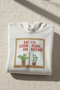 White pullover hoodie with front pouch pocket and “Coffee, Lesson Plans, and Patience” graphic