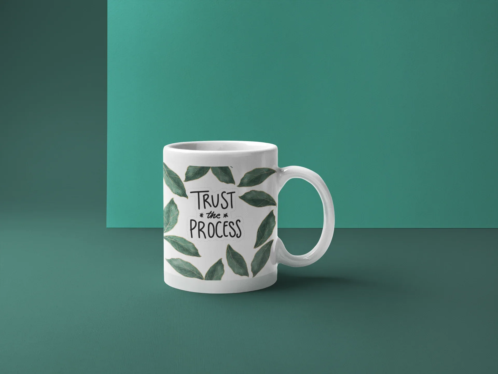 11oz white coffee mug with green leaf wreath and “Trust the Process” text