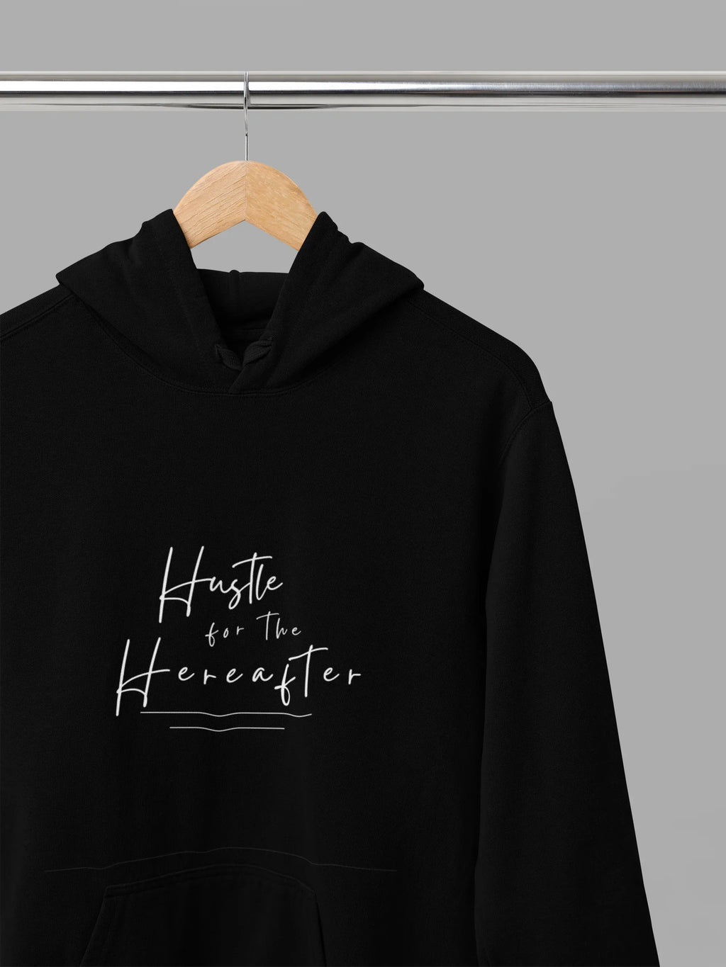 Black hooded sweatshirt hanging with front pouch pocket and chest script graphic