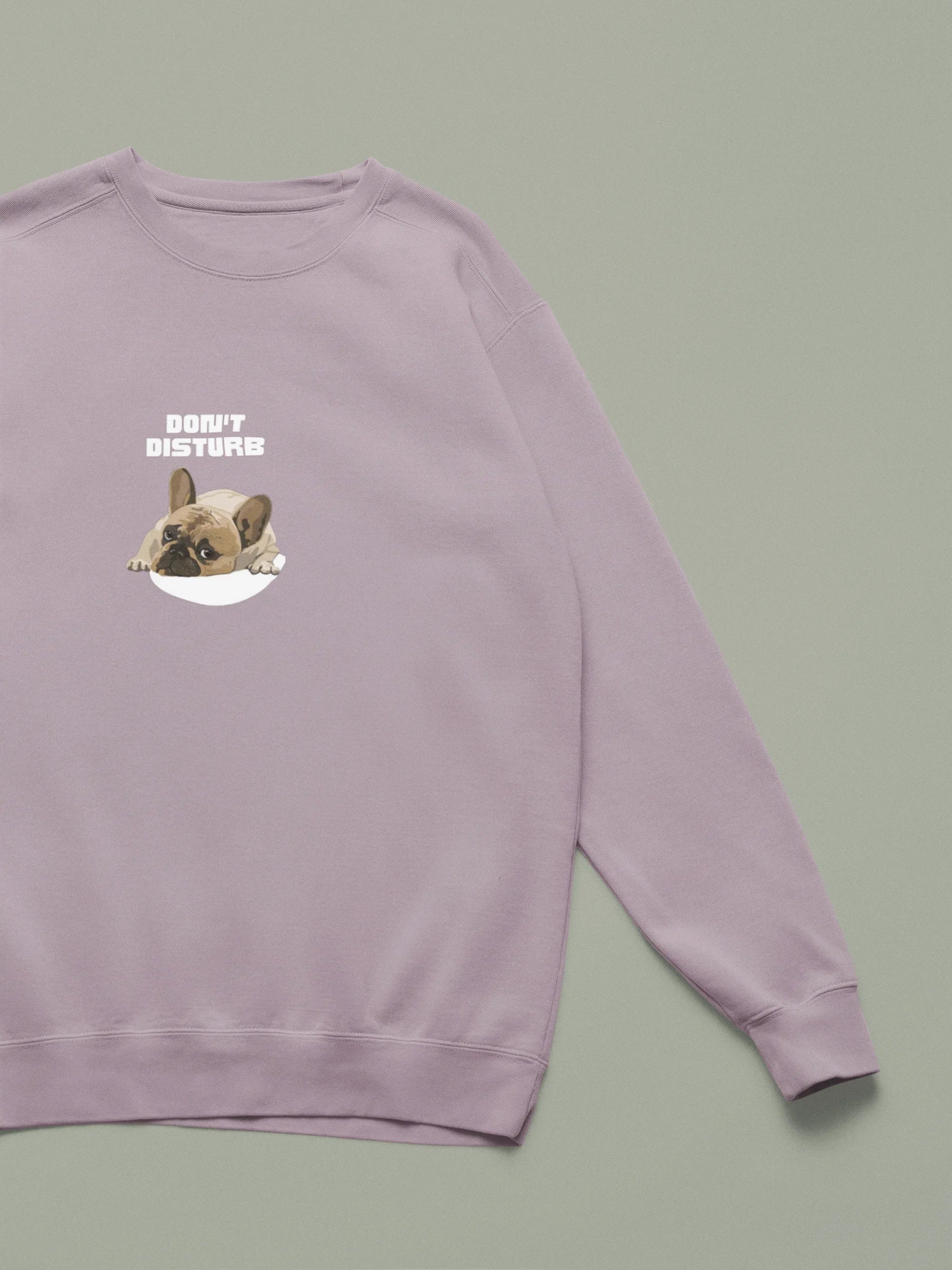Dusty pink sweatshirt with “DON’T DISTURB” text and sleeping French Bulldog graphic.
