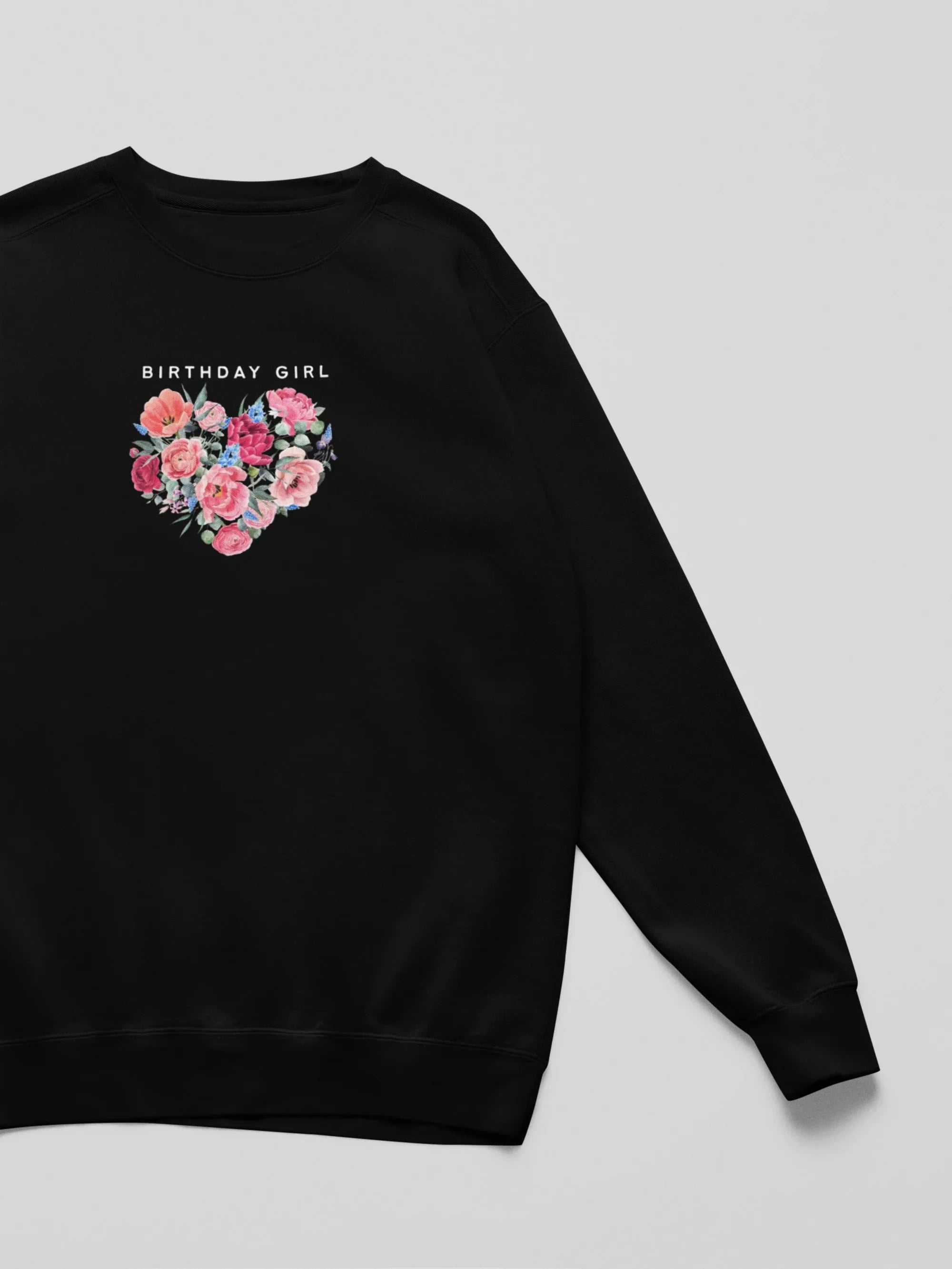 Black crewneck sweatshirt sleeve and front print with floral heart and “Birthday Girl”