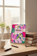Butterfly spiral notebook with pink name label reading “NOTEBOOK” and “CLAUDIA ALVES”