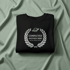 Black crewneck sweatshirt with “Completed Another Orbit” circular logo, front view