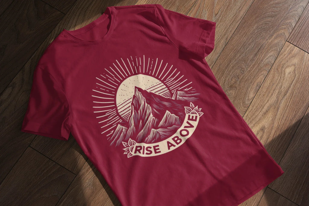 Maroon short-sleeve T-shirt with mountain sunrise “RISE ABOVE” graphic