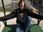 Black crewneck sweatshirt with round space logo graphic on front.