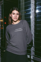 Dark gray crewneck sweatshirt with "a year wiser, a world kinder" text on chest