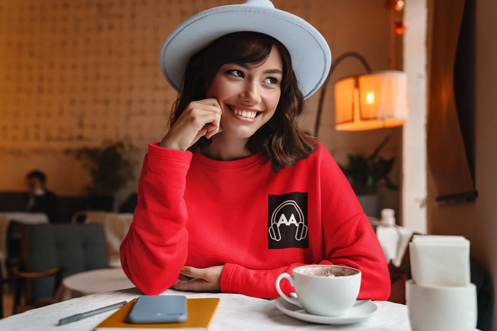 Red unisex sweatshirt with embroidered headphone logo on the chest