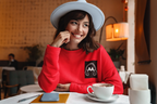 Red unisex sweatshirt with embroidered headphone logo on the chest