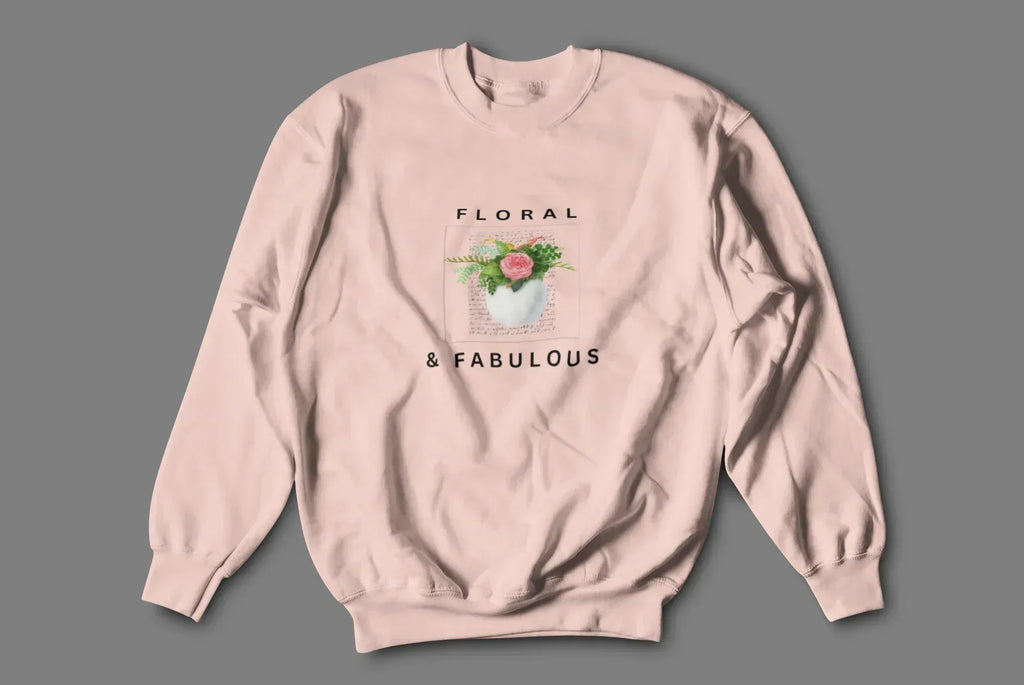 Dusty pink sweatshirt with floral graphic and "FLORAL" and "& FABULOUS" text