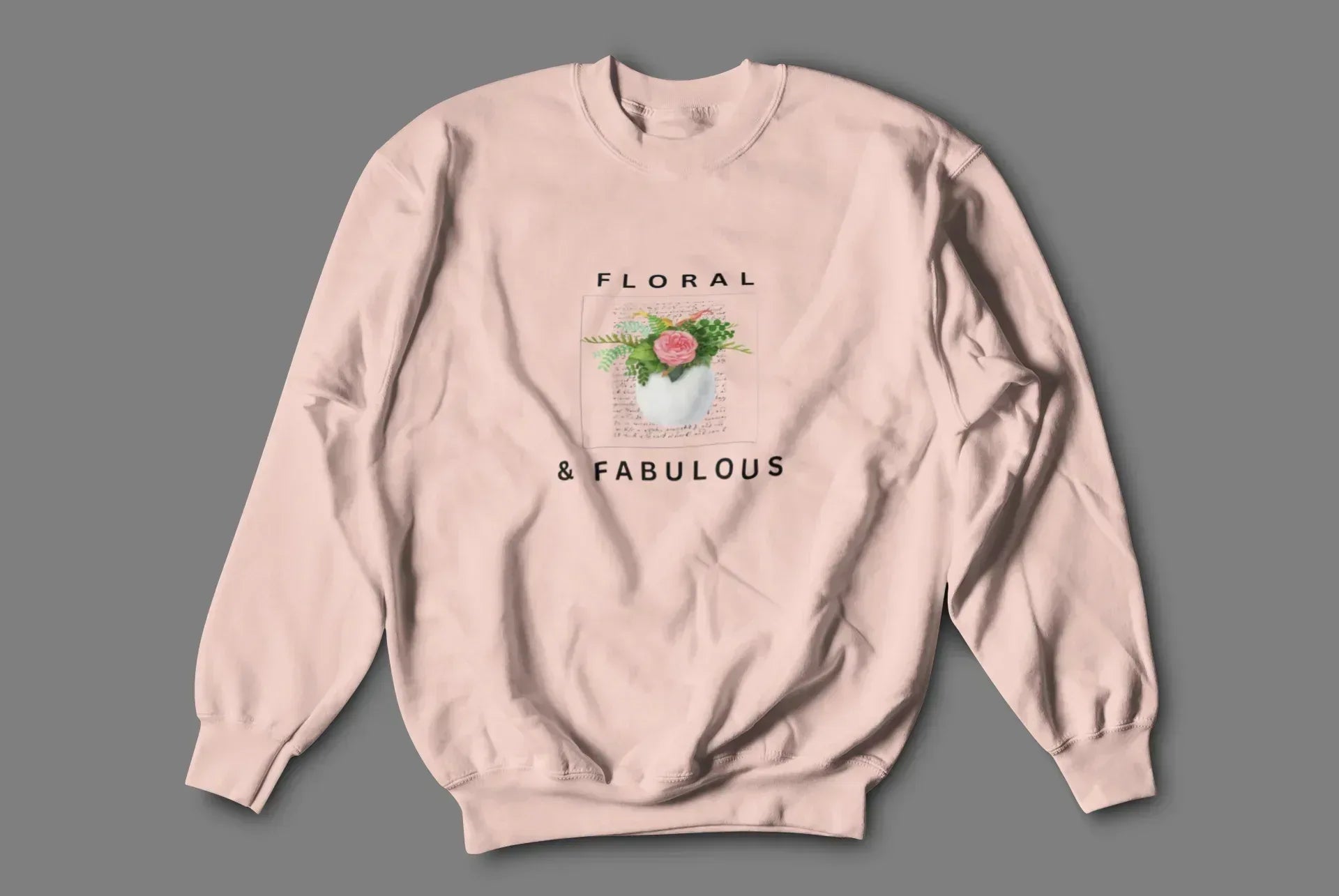 Dusty pink sweatshirt with floral graphic and "FLORAL" and "& FABULOUS" text