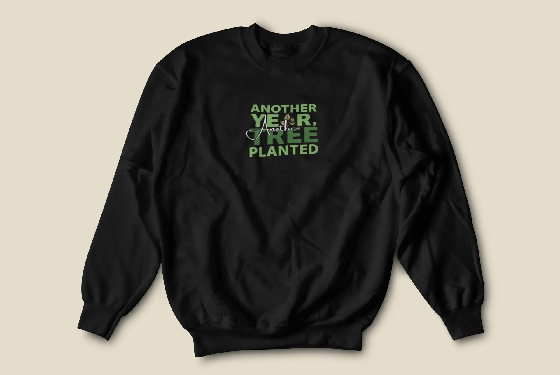Black crewneck sweatshirt with small green “Another Year, Tree Planted” chest graphic.