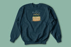 Dark teal crewneck sweatshirt with “Happy birthday” cake and candle graphic