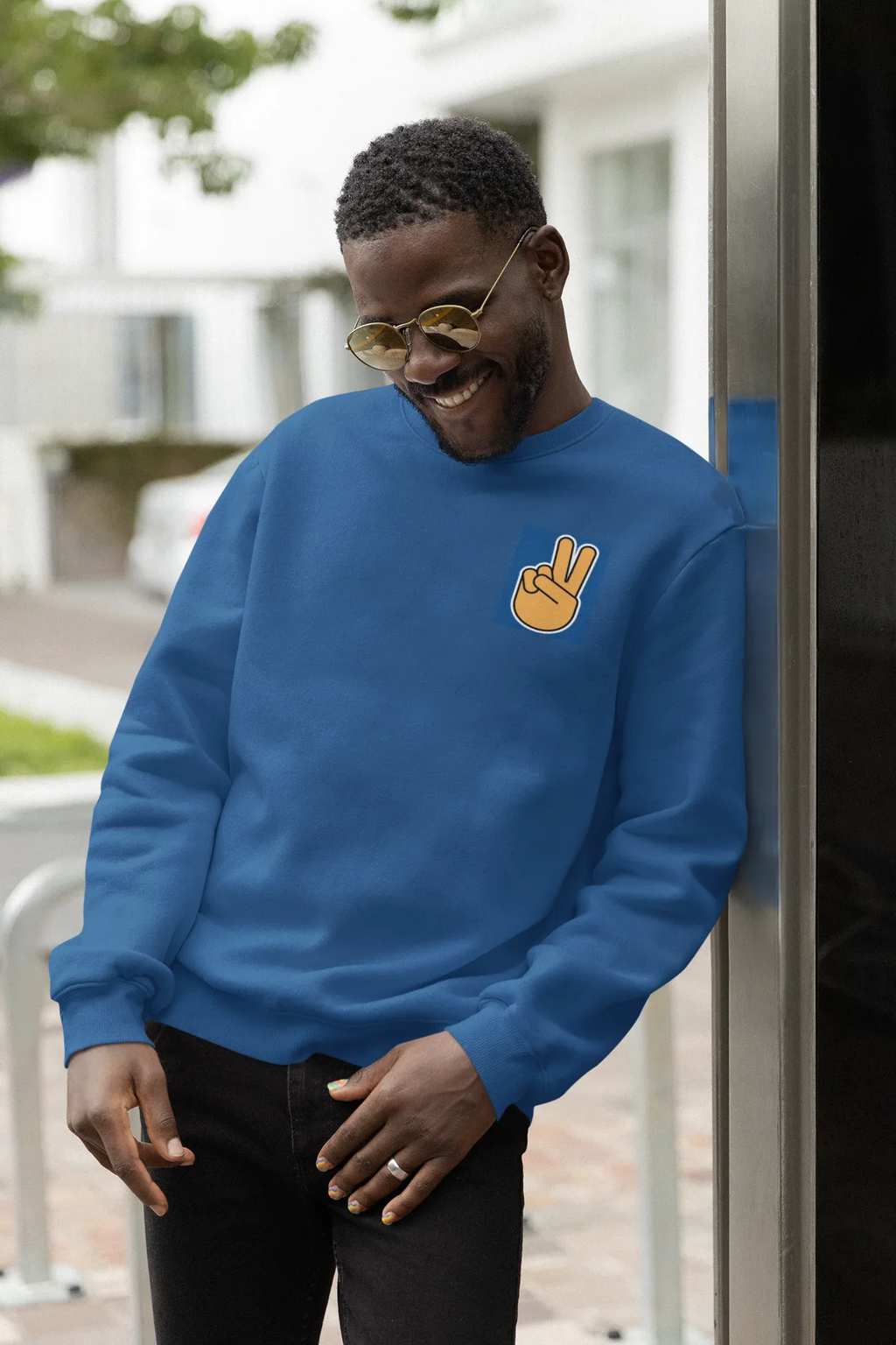 Royal blue crewneck sweatshirt with embroidered peace hand sign on front.