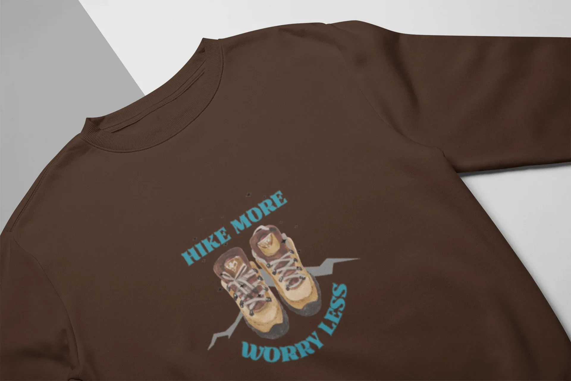 Brown crewneck sweatshirt with 'Hike More, Worry Less' hiking boots graphic on chest