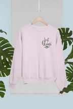 Light pink crewneck sweatshirt with small “Just Bloom” floral graphic