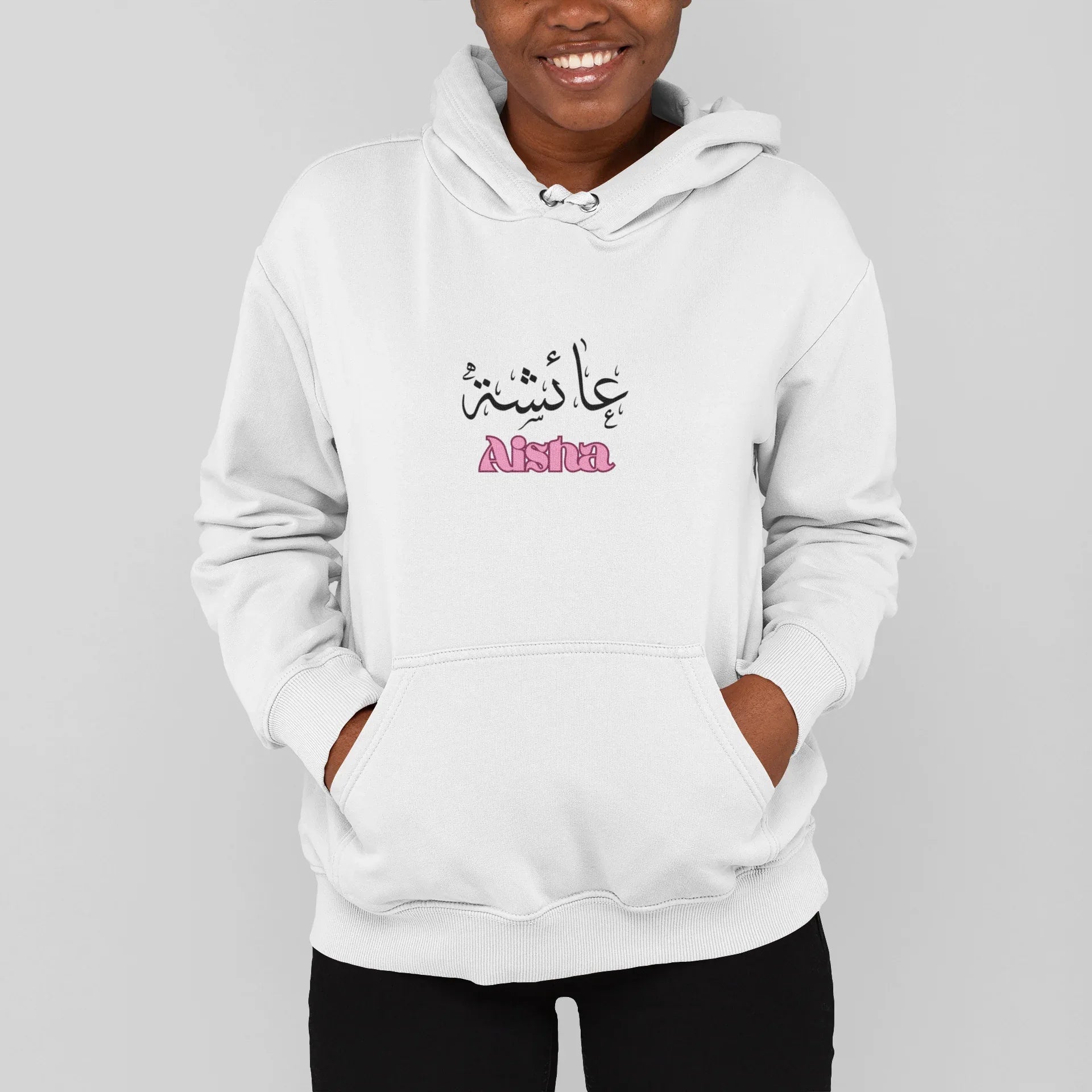 Kids white pullover hoodie with Arabic name and pink “Aisha” chest print
