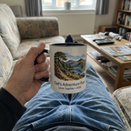 Dad’s Adventure Fuel mug held on a sofa