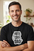 Black crewneck graphic T-shirt with centered Reel Cool Dad logo and EST. 2024