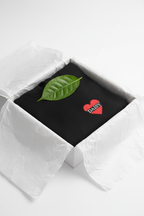 Black hoodie with red heart patch and green leaf graphic on the chest