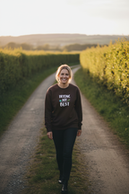 Brown sweatshirt with “TRYING MY BEST” quote print on the chest.