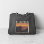 Dark heather crewneck sweatshirt with mountain sunset graphic on the chest