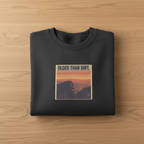 Dark heather crewneck sweatshirt with centered mountain sunset graphic