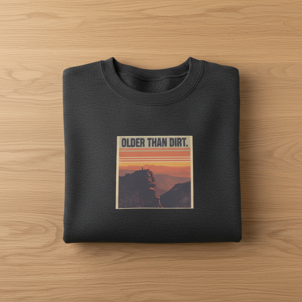 Dark heather crewneck sweatshirt with centered mountain sunset graphic