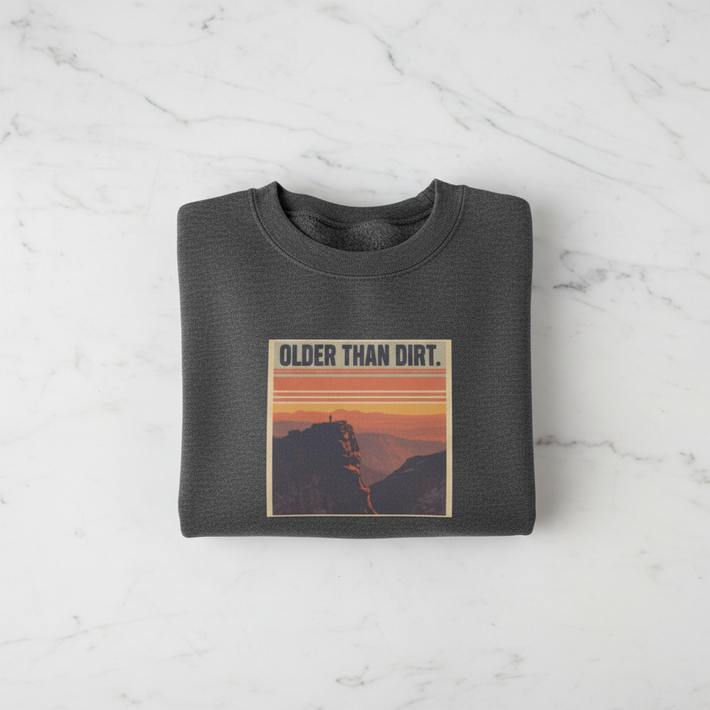 Dark heather crewneck sweatshirt with mountain sunset graphic and banner-style text