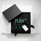 Black sweatshirt with 'PLANT' text and plant icon, folded in gift box