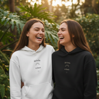White and black pullover hoodies with drawstring hoods and small chest slogan print