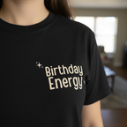 Black Birthday Energy T-shirt with front text graphic and small sparkle accents