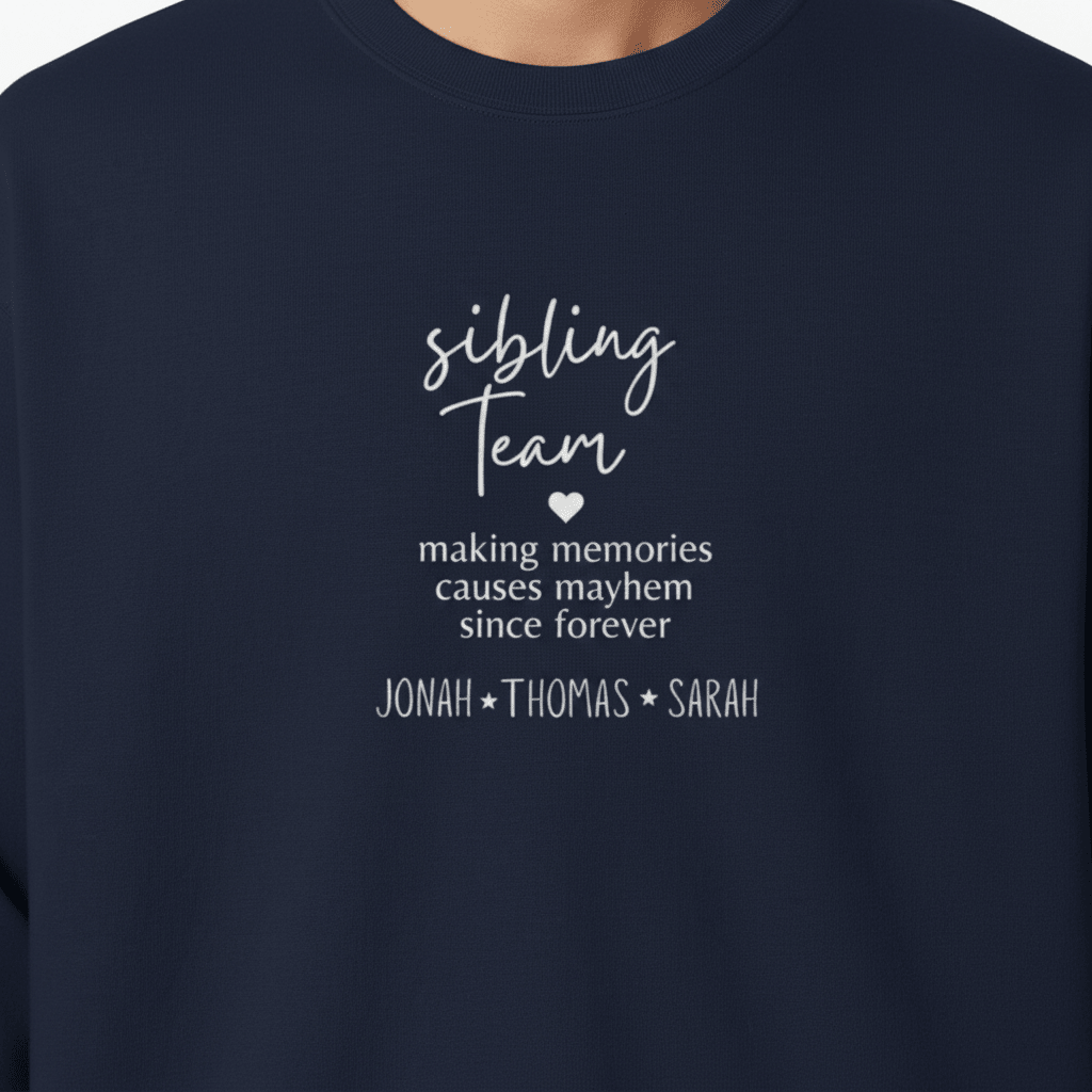 Close-up of navy crewneck chest print: 'sibling team' quote