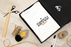 White unisex t-shirt with “Teaching is a work of heart” text and heart icon
