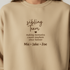 Sand crewneck sweatshirt with 'sibling Team' text, heart, and names Mia, Jake, Zoe