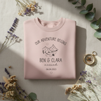 Dusty pink sweatshirt flat lay with compass and map