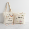 Two cream tote bags with ELLIE and BETH floral prints, The original and Est.