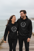 Black couples hoodies with 'Still waiting on the honeymoon' wreath design, front view