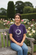 Purple graphic T-shirt with sun-and-moon emblem print at center.