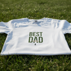 White dad T-shirt with centered green 'Best Dad' graphic text