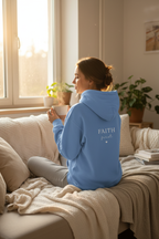 Light blue unisex hoodie sweatshirt with back hood and “FAITH first” graphic