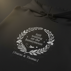Black hoodie close-up: white wreath “Still waiting on the honeymoon” print